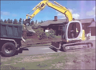 GIF of loading an excavator into a dump truck.